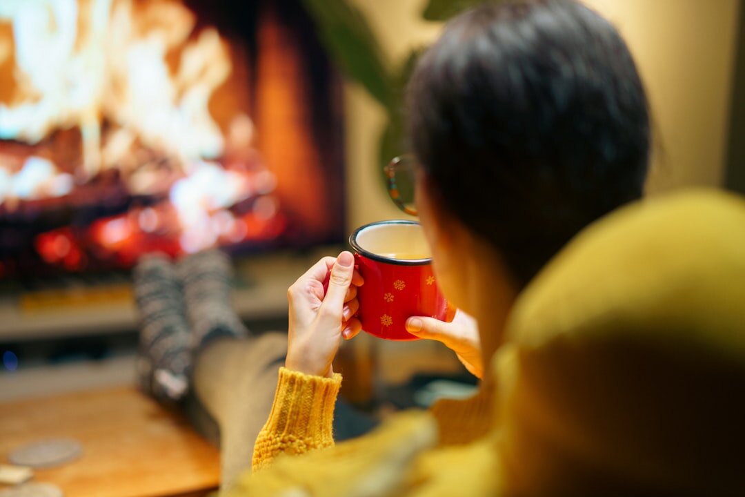 Person watching an old television set in a cosy living room